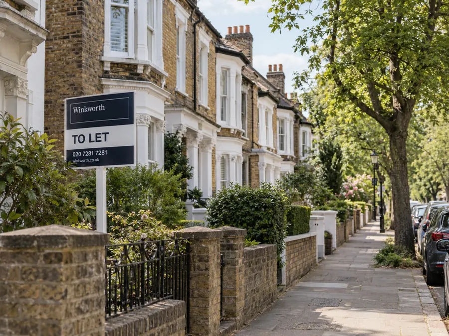 Street of terraced houses with To Let boards
